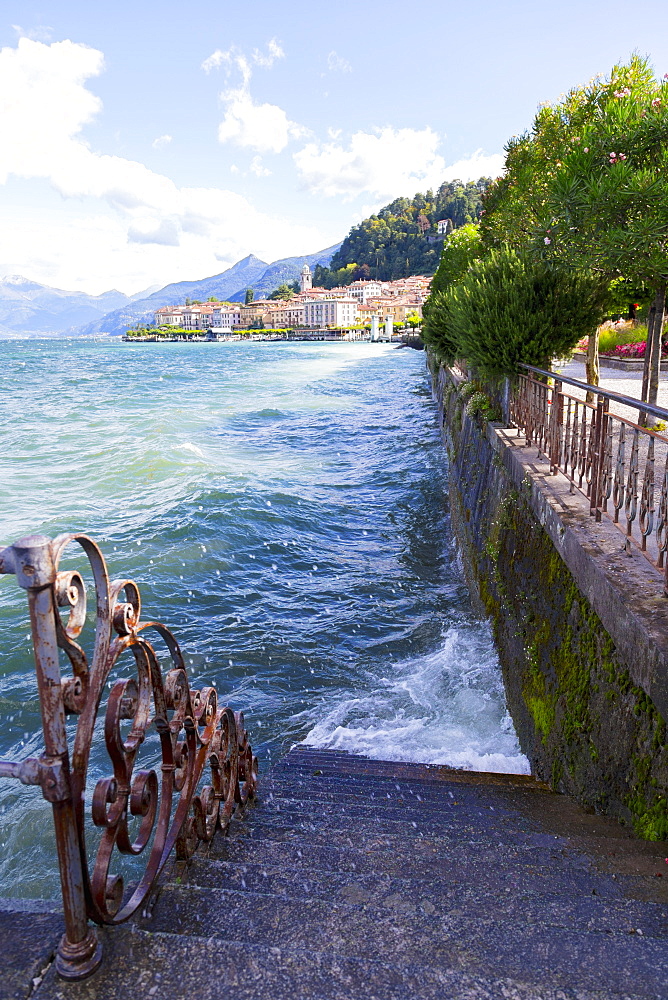 Wind Sends Lake Como Water Splashing Against A Waterfront Staircase And Sidewalk, Bellagio, Italy