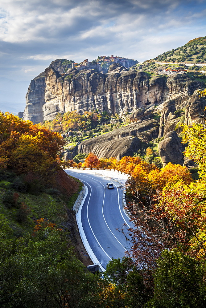 Monasteries Perched On Cliffs And A Winding Road In Autumn Foliage, Meteora, Greece