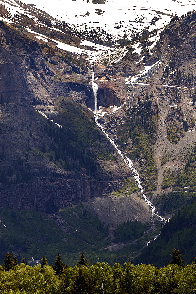 Distant Mountain Waterfall And Cascading Stream Tumbling Down The Mountainside, Colorado, United States Of America