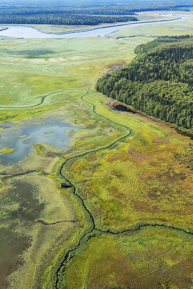 View Of The Susitna Flats Outside Anchorage On A Charter Airplane Tourist Flight In Summertime With A Duck Shack Sitting On The Flats Below, Alaska, United States Of America