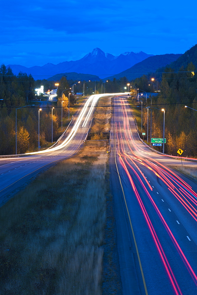 Long Exposure Of Evening Traffic On The Glenn Highway Near Eagle River, Alaska, United States Of America