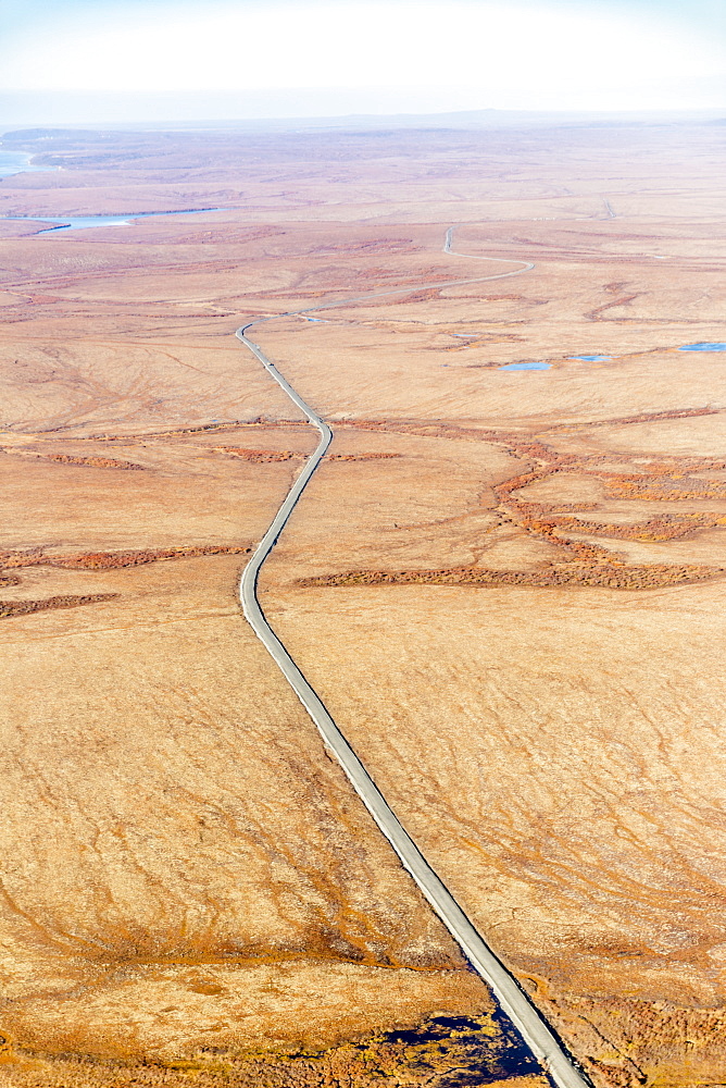 Aerial View Of Autumn Coloured Tundra Surrounding The Gravel Road Which Connects St. Mary's To Mountain Village, Yukon Delta, Arctic Alaska, Saint Mary's, Alaska, United States Of America