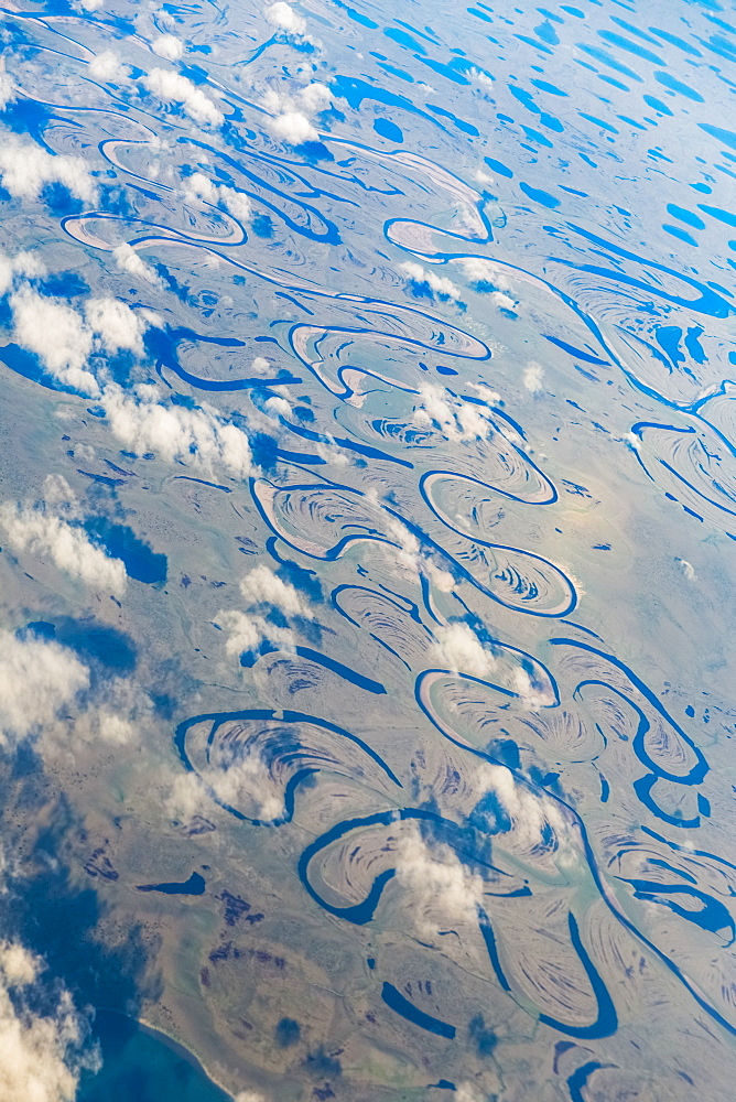 Aerial View Of Oxbow Rivers And Streams And Clouds Stretch Through The Tundra Landscape, North Slope, Alaska, United States Of America