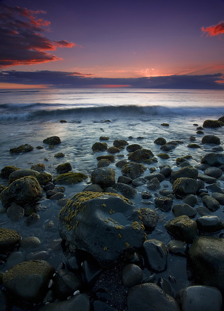 Pink Clouds At Sunset With The Surf Rolling Into The Rocks Along The Coast Of A Hawaiian Island, Hawaii, United States Of America