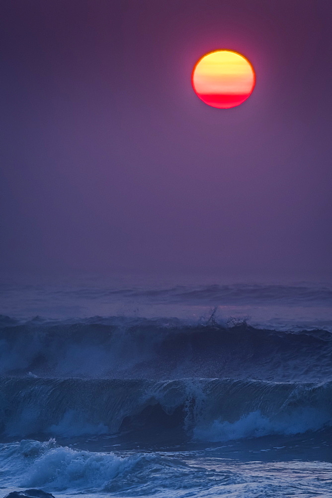 Smoke in the air colors the sun on a summer evening, Seaside, Oregon, United States of America