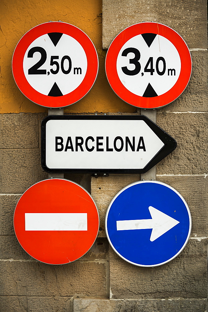 Road Signs Mounted On A Wall, Barcelona, Catalonia, Spain