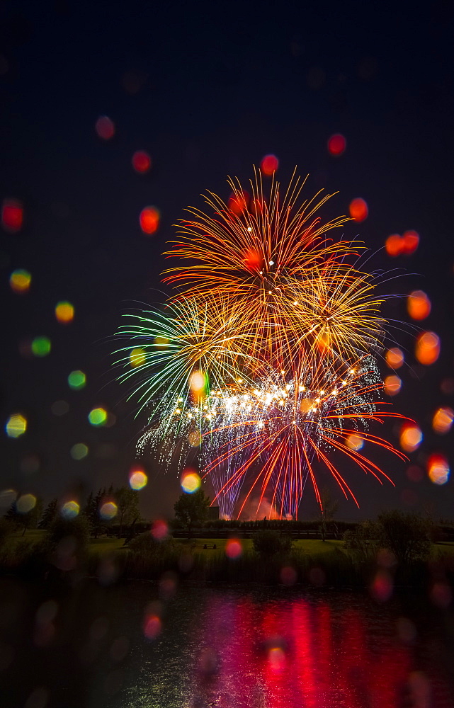 Colourful Fireworks Display Reflected In Water On Canada Day, Edmonton, Alberta, Canada