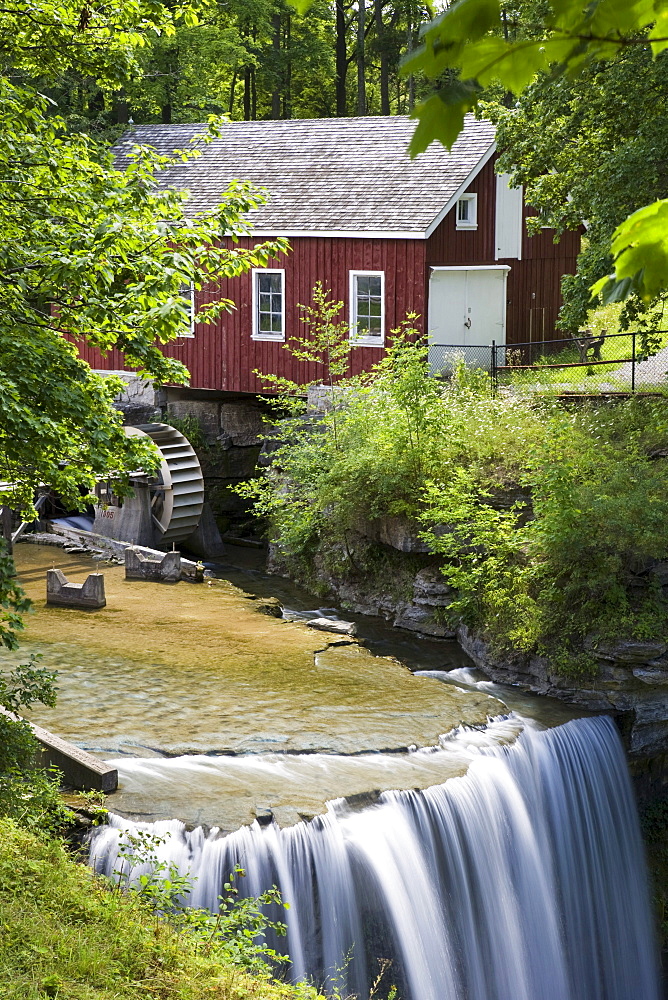 Red Barn With A Mill Wheel And Waterfall; Thorold, Ontario, Canada