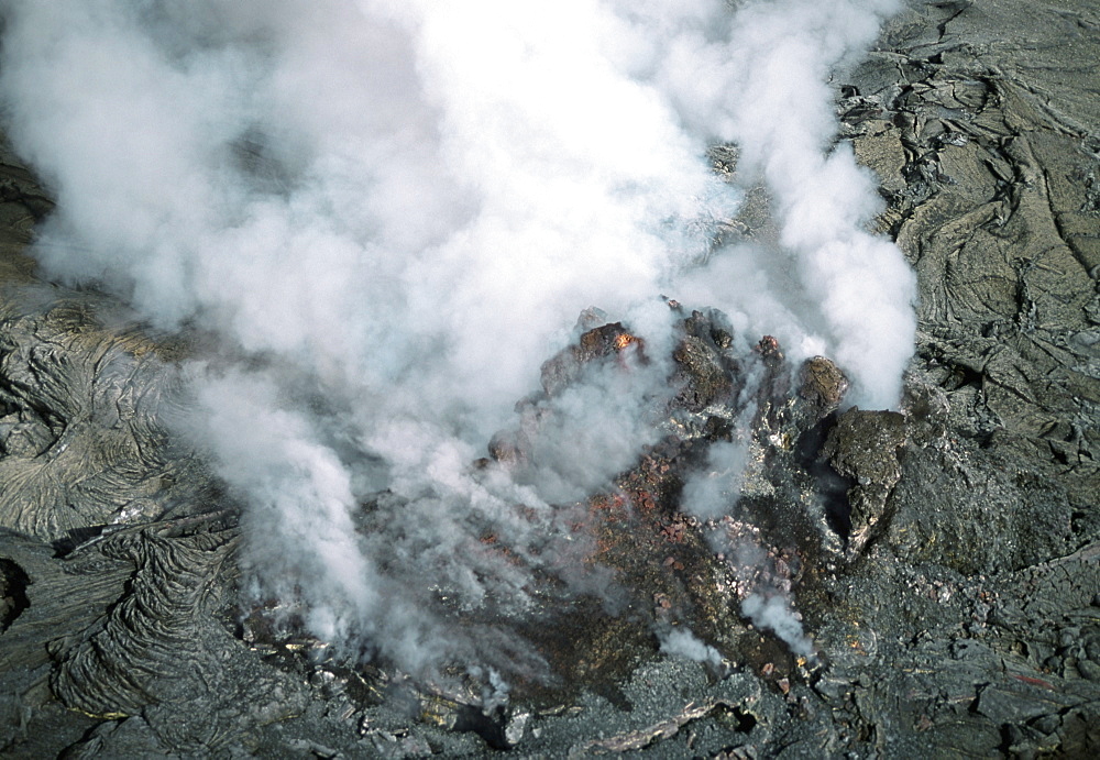 Plumes of stream rising from molten lava, Hawaii 