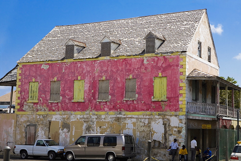 Two vehicles parked beside a house, Bay Street, Nassau, Bahamas