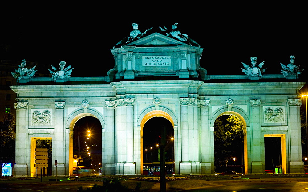 Memorial gate lit up at night, Alcala Gate, Madrid, Spain