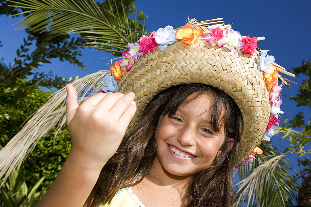 Portrait of a girl wearing a straw hat and smiling