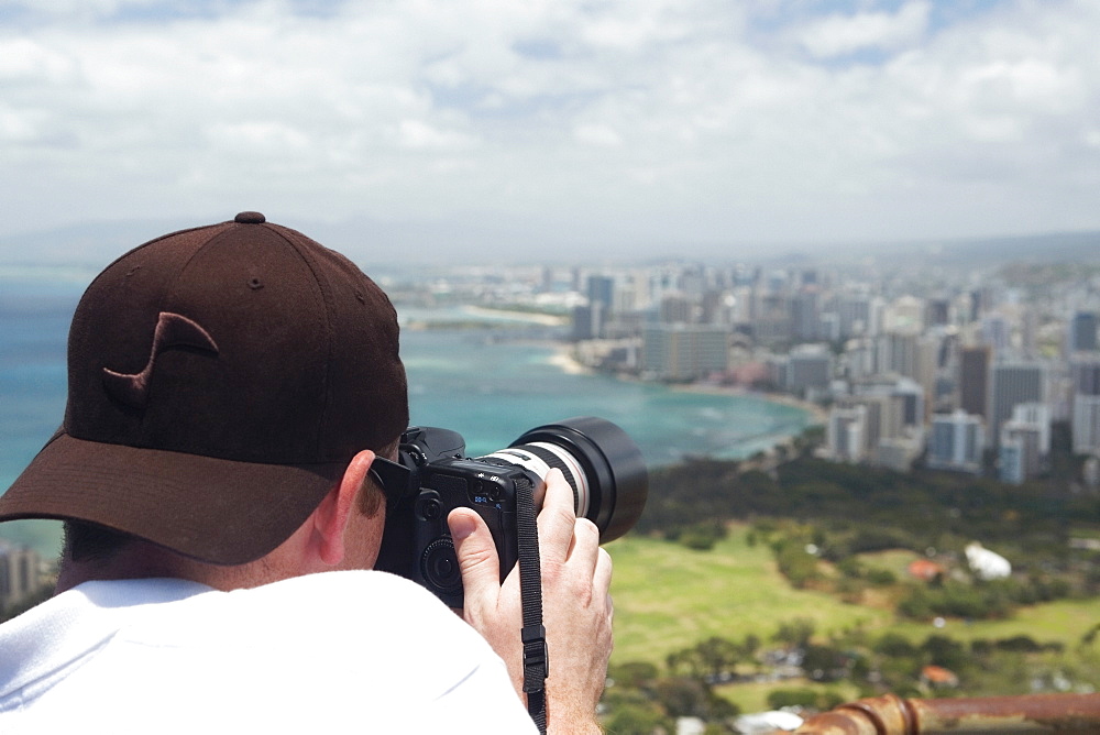 Rear view of a man taking a photograph, Diamond Head, Waikiki Beach, Honolulu, Oahu, Hawaii Islands, USA