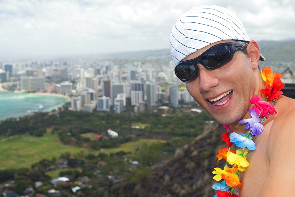 Close-up of a young man smiling, Diamond Head, Waikiki Beach, Honolulu, Oahu, Hawaii Islands, USA