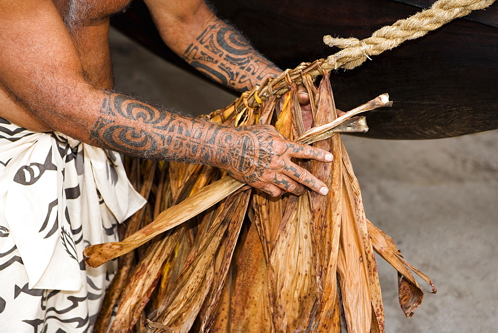 Mid section view of a man making a rope, Puuhonua O Honaunau National Historical Park, Kona Coast, Big Island, Hawaii Islands, USA