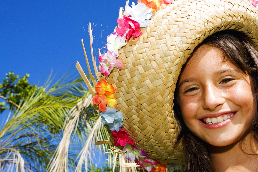 Portrait of a girl wearing a straw hat and smiling