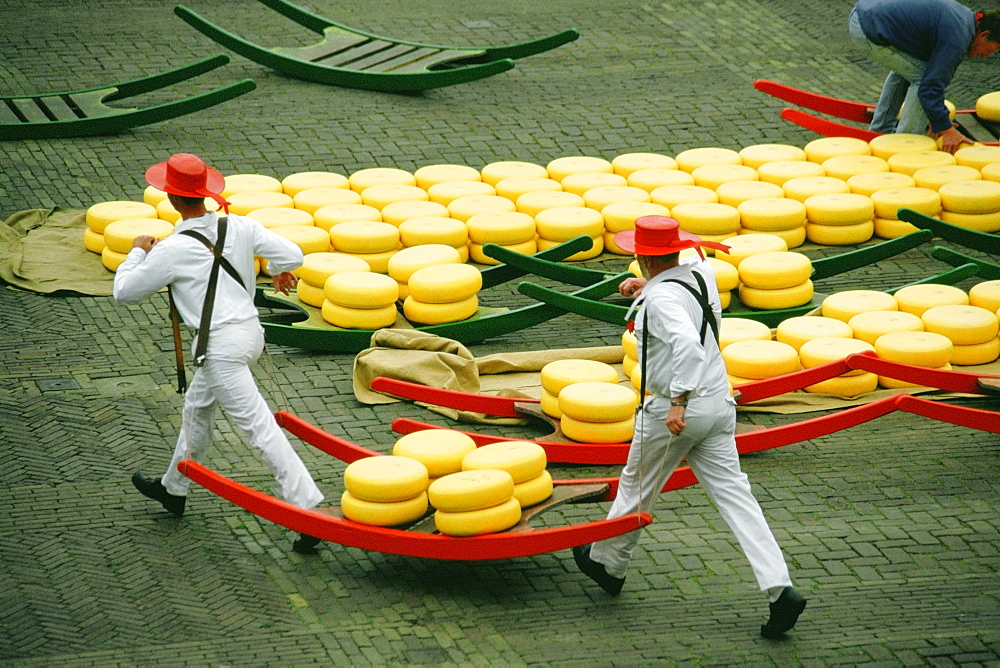 High angle view of two men carrying cheese, Alkmaar Cheese Market, Alkmaar, Netherlands