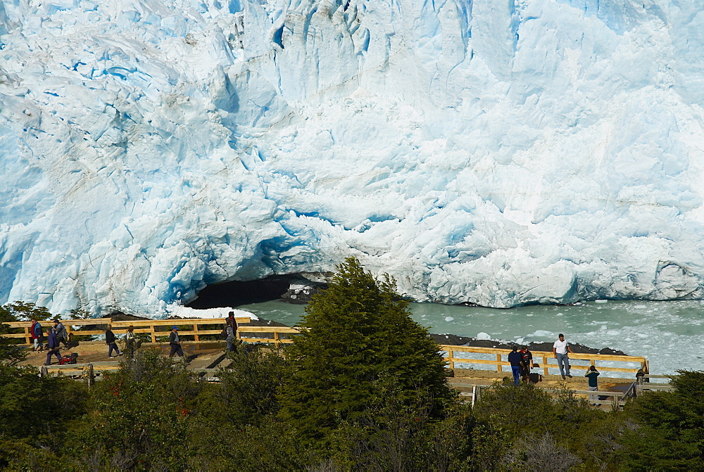 High angle view of tourists in front of a glacier, Moreno Glacier, Argentine Glaciers National Park, Lake Argentino, El Calafate, Patagonia, Argentina