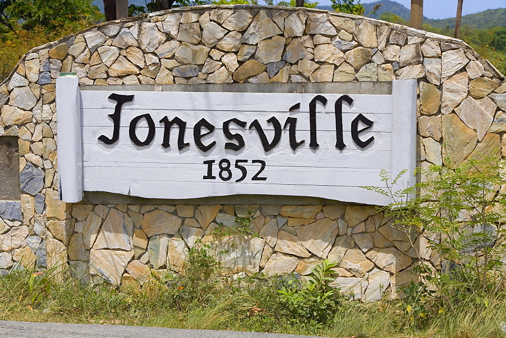 Information board on a stone wall, Jonesville, Roatan, Bay Islands, Honduras