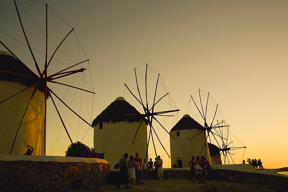 Low angle view of traditional windmills at dusk, Mykonos, Cyclades Islands, Greece