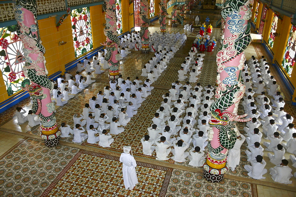 High angle view of a group of people praying in a monastery, Cao Dai Monastery, Tay Ninh, Vietnam