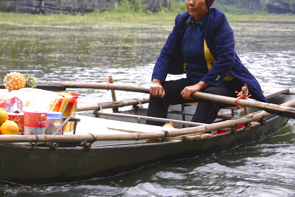 Female vendor in a boat at a floating market, Dong Hoi, Vietnam