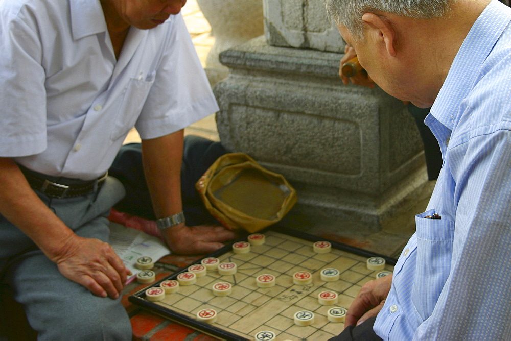 Two mature men playing a board game, Hanoi, Vietnam