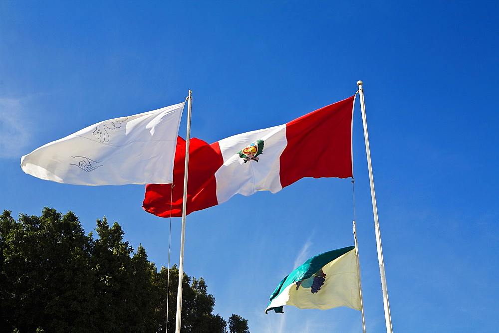 Low angle view of flags fluttering, Plaza-De-Armas, Pisco, Ica Region, Peru