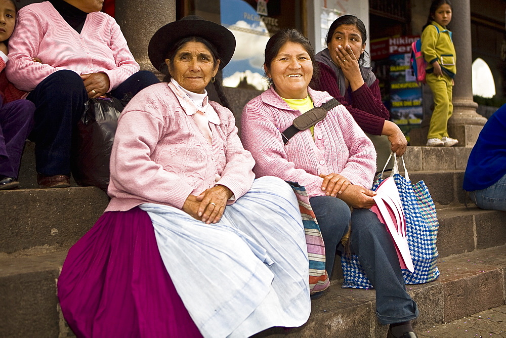 Portrait of a senior woman with a mid adult woman sitting on steps, Peru