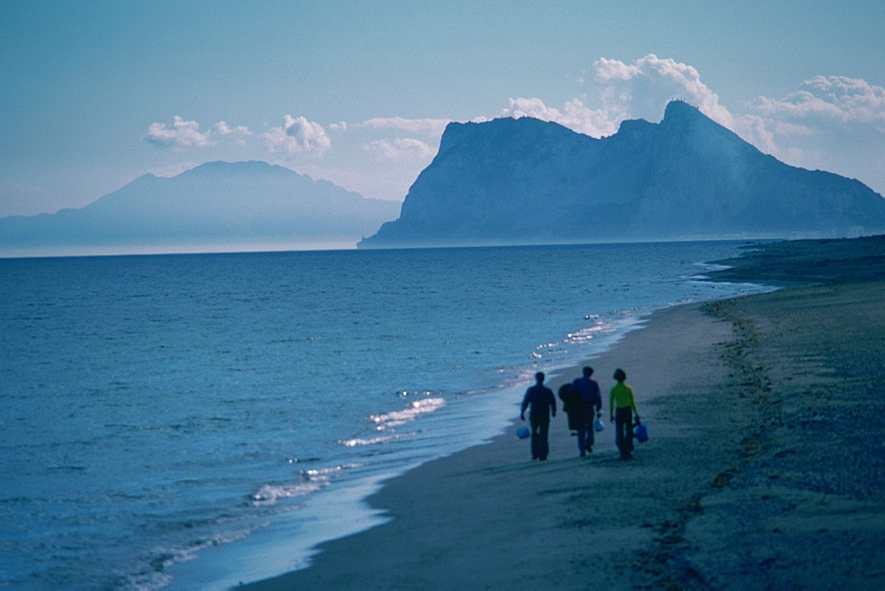 Three people walking on the beach, Rock of Gibraltar, Gibraltar, Spain