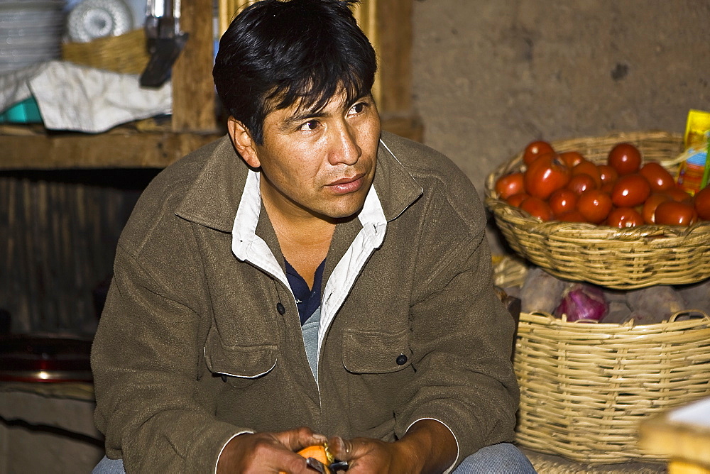 Close-up of a mature man sitting at a market stall, San Juan de Chuccho, Peru