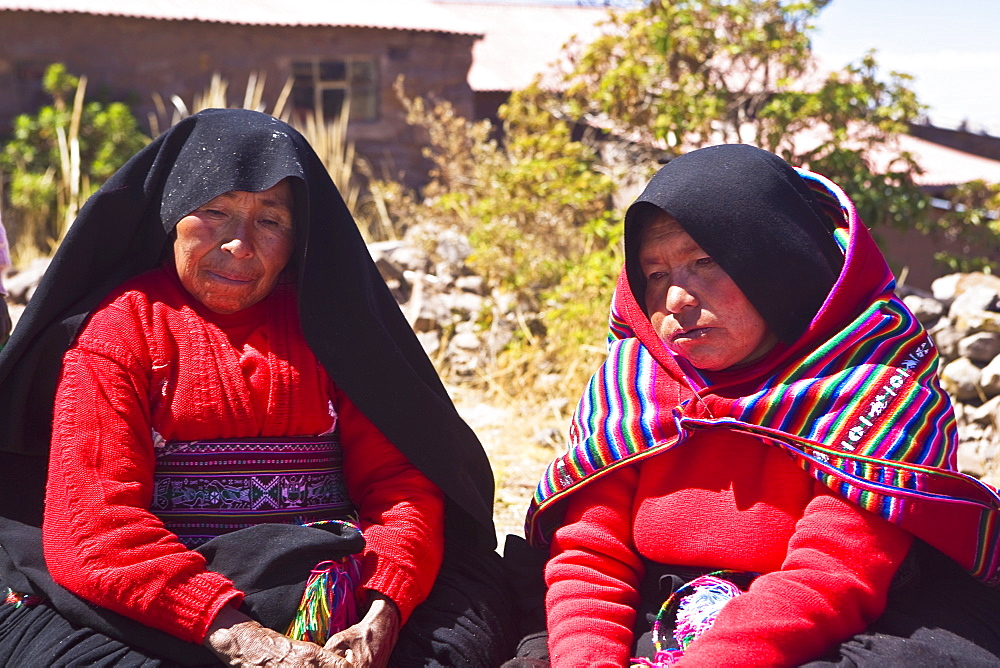 Close-up of two mature women taking part in a wedding ceremony, Taquile Island, Lake Titicaca, Puno, Peru