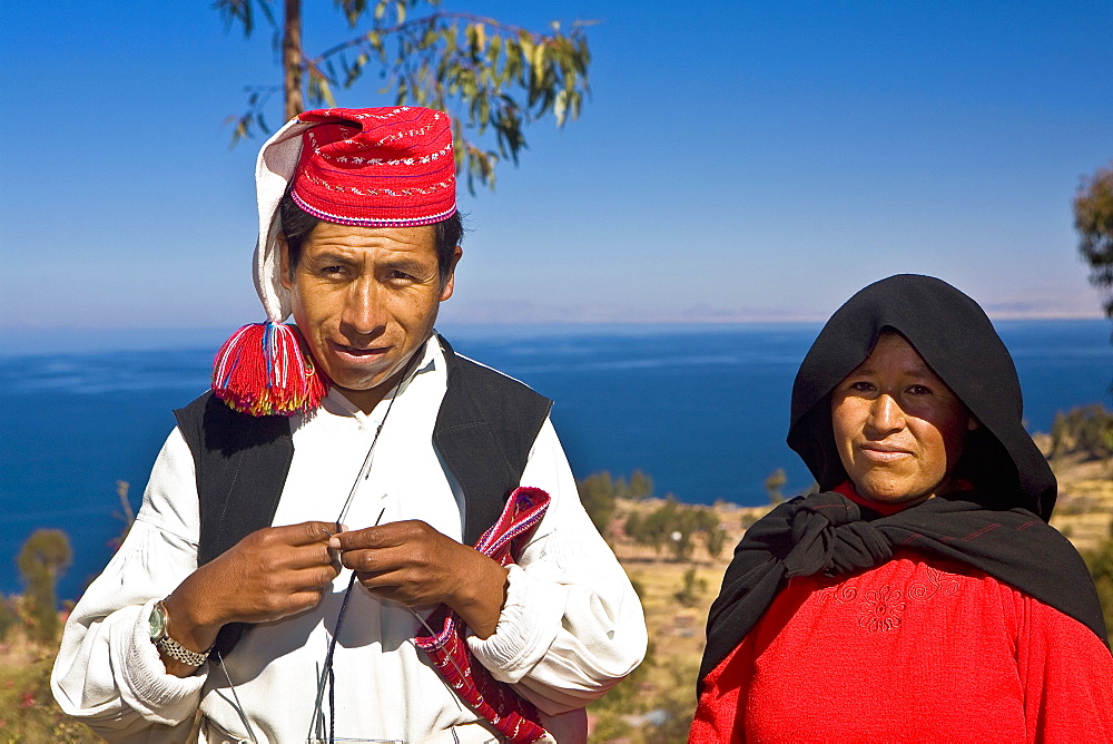 Portrait of a newlywed young couple standing, Taquile Island, Lake Titicaca, Puno, Peru