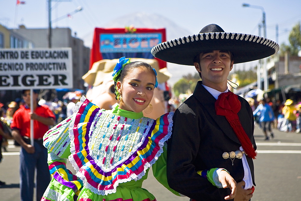 Portrait of a young couple with arm in arm in a parade, Arequipa, Peru