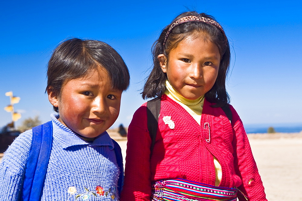 Portrait of a girl with a boy, Taquile Island, Lake Titicaca, Puno, Peru