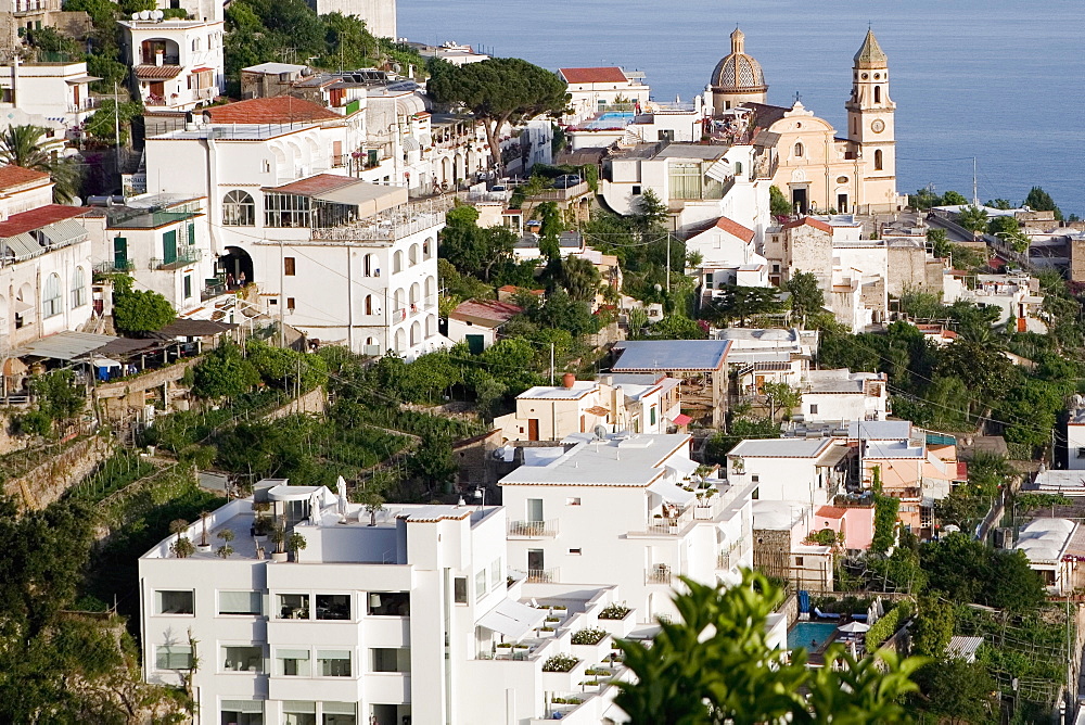 High angle view of buildings in a town with a church in the background, Parrocchiale di San Gennaro, Amalfi Coast, Maiori, Salerno, Campania, Italy