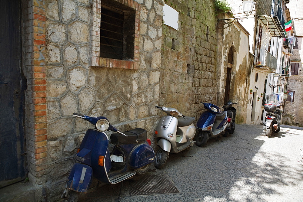 Motor scooters parked in front of buildings, Sorrento, Sorrentine Peninsula, Naples Province, Campania, Italy