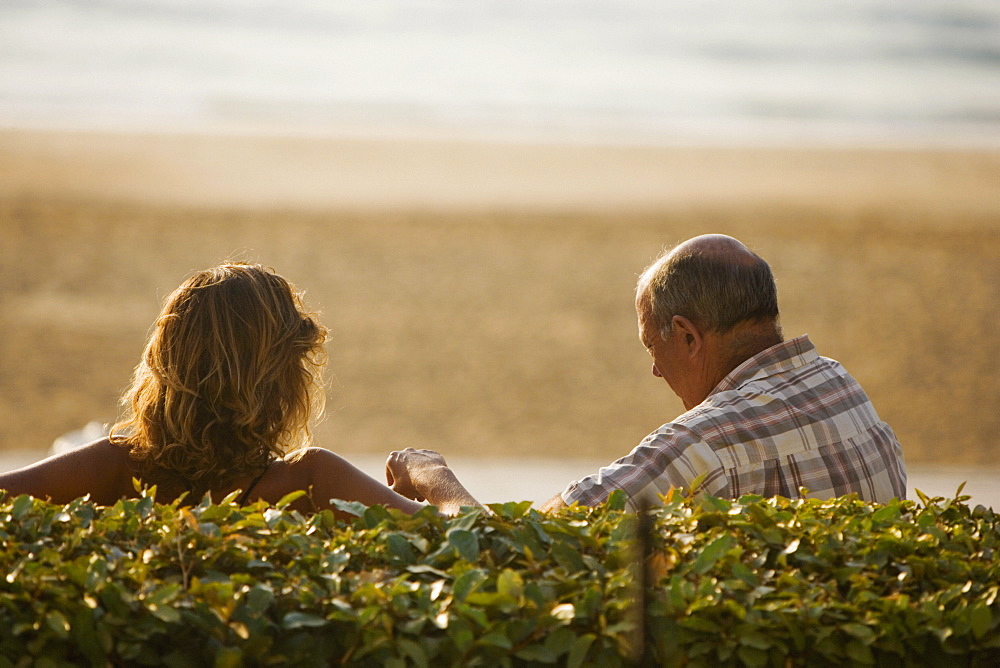 Rear view of a couple, Grande Plage, Biarritz, France