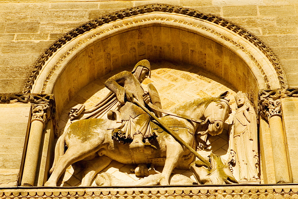 Low angle view of statues carved on the wall of a church, Eglise Sainte-Croix, Bordeaux, France