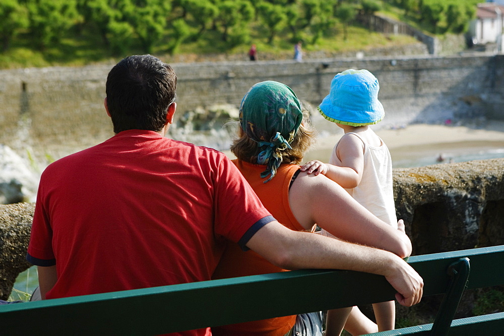 Rear view of a family on a bench, Biarritz, Basque Country, Pyrenees-Atlantiques, Aquitaine, France