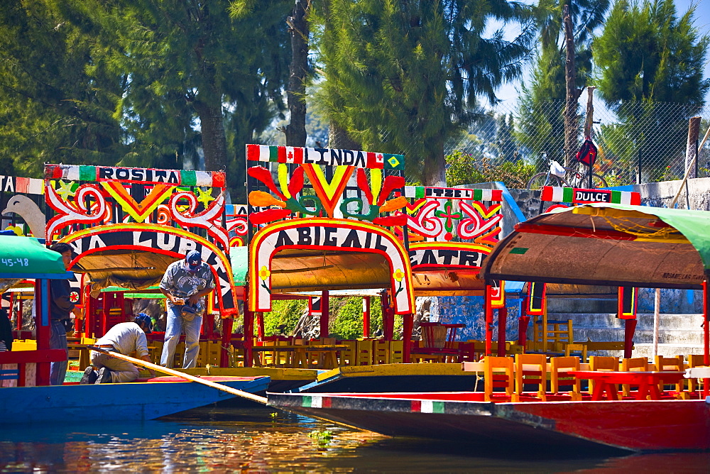 Two men on a trajineras boat, Xochimilco Gardens, Mexico City, Mexico