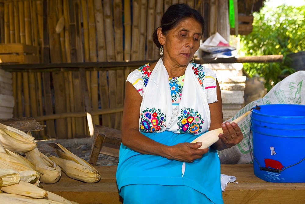 Mature woman peeling corn, Papantla, Veracruz, Mexico