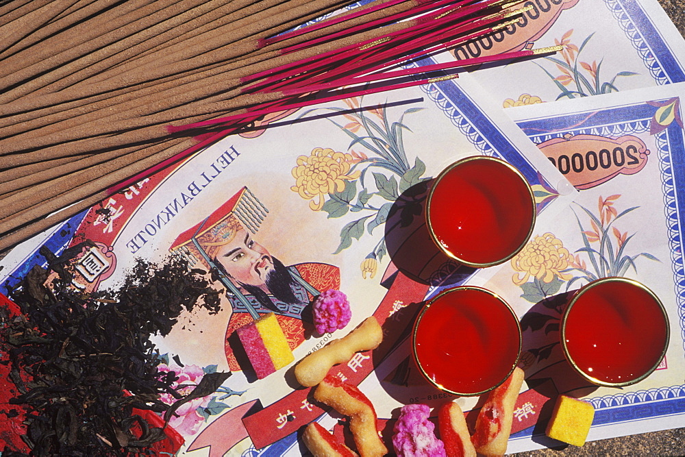 High angle view of incense sticks with bank notes and candles