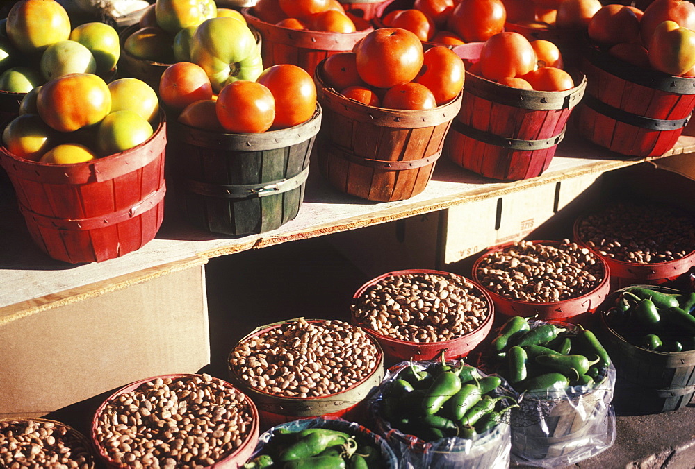 Close-up of tomatoes with beans and peppers in baskets