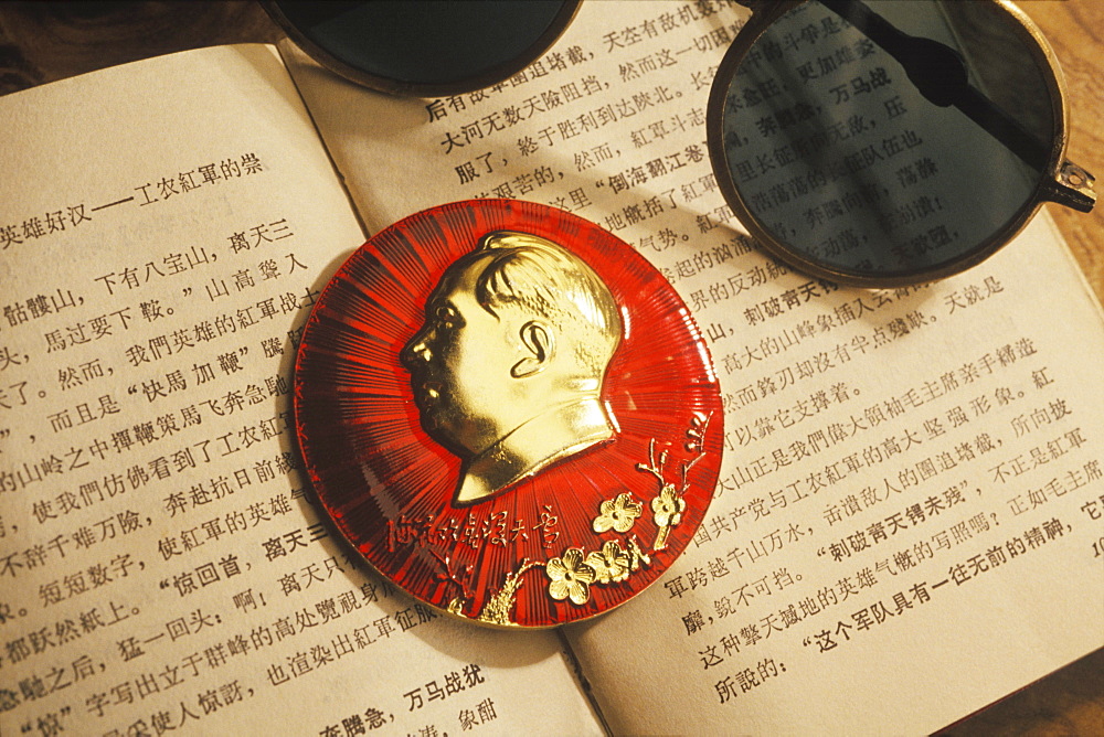 Close-up of a paperweight and sunglasses on an open book