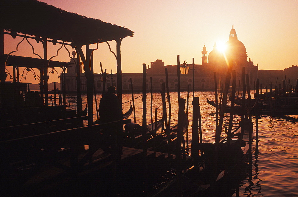 Gondolas moored at a dock