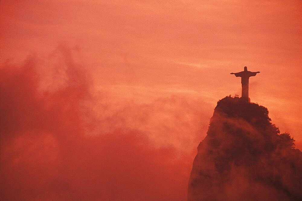 Statue of Jesus Christ on a hill at sunset, Christ the Redeemer Statue, Rio De Janeiro, Brazil