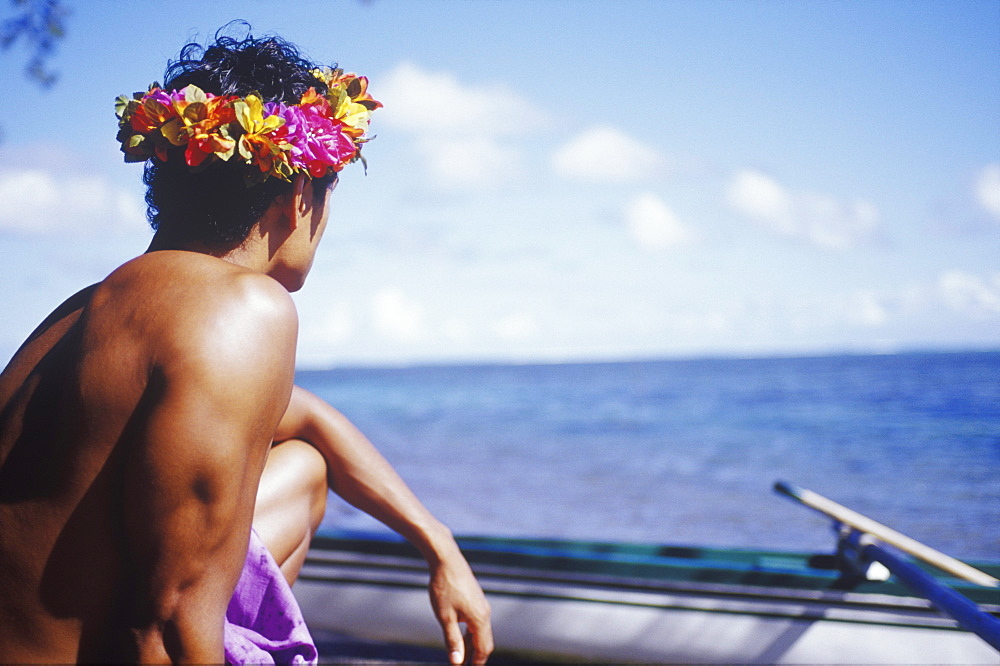 Close-up of a young man looking at a boat, Hawaii, USA