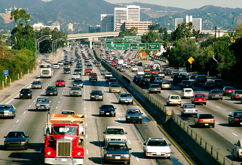 Traffic on Los Angeles highway and with office buildings in the background