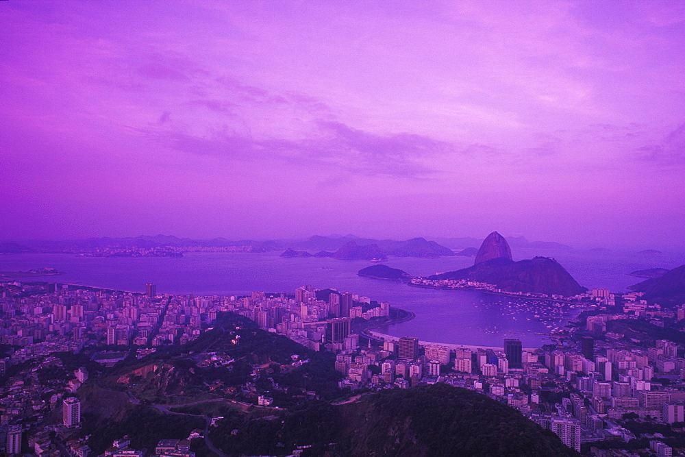 Aerial view of city by the sea at dusk